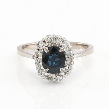 Ring in 18K white gold with an oval faceted sapphire and round brilliant-cut diamonds.