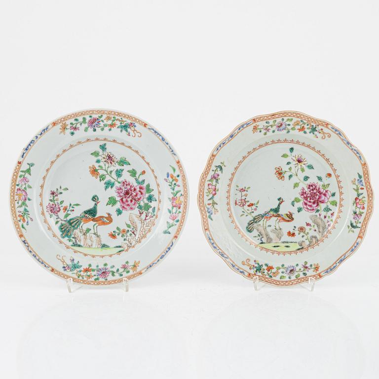 A set of three famille rose 'double peacock' dinner plates and an odd serving dish, Qing dynasty, Qianlong (1736-95).