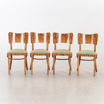 A set of four mid 20th century chairs in walnut.