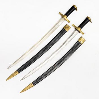 Two Swedish cutlasses 1856 pattern, with scabbards.