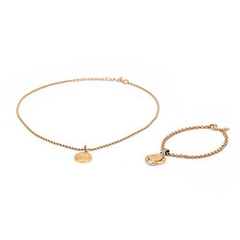 BUBERRY, a gold colored necklace and bracelet.