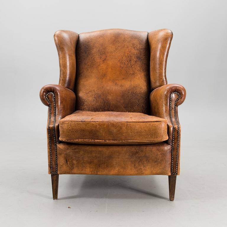 A Chesterfield style armchair from the latter part of the 20th century.