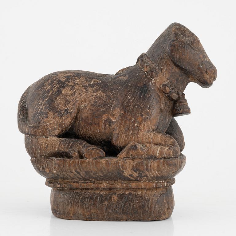 A wooden sculpture of a cow.