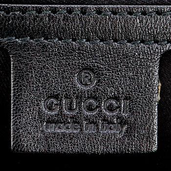 GUCCI, a black monogramed canvas shoulder bag.