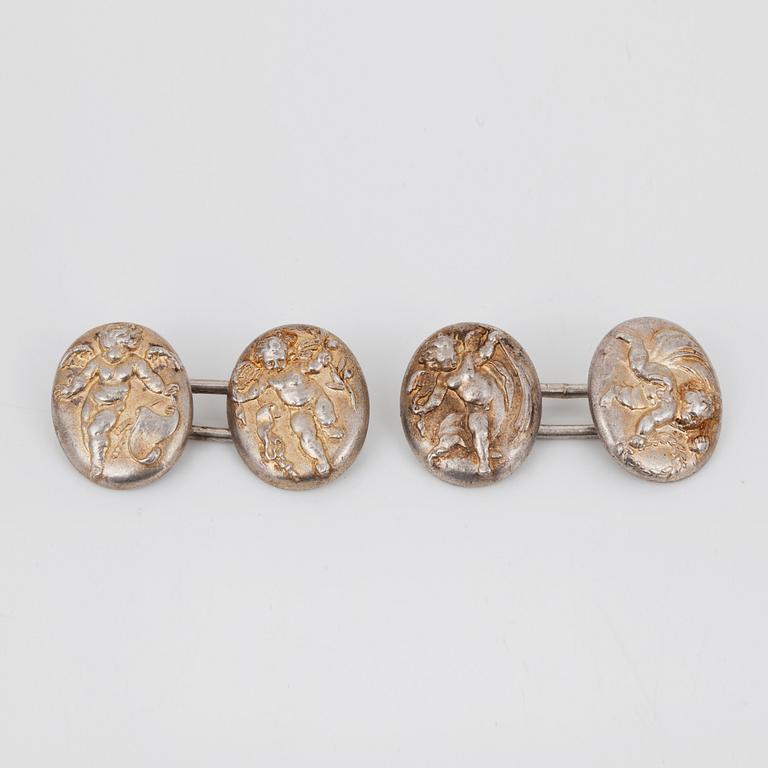 A pair of cherub motif cufflinks by Alfred Philips.