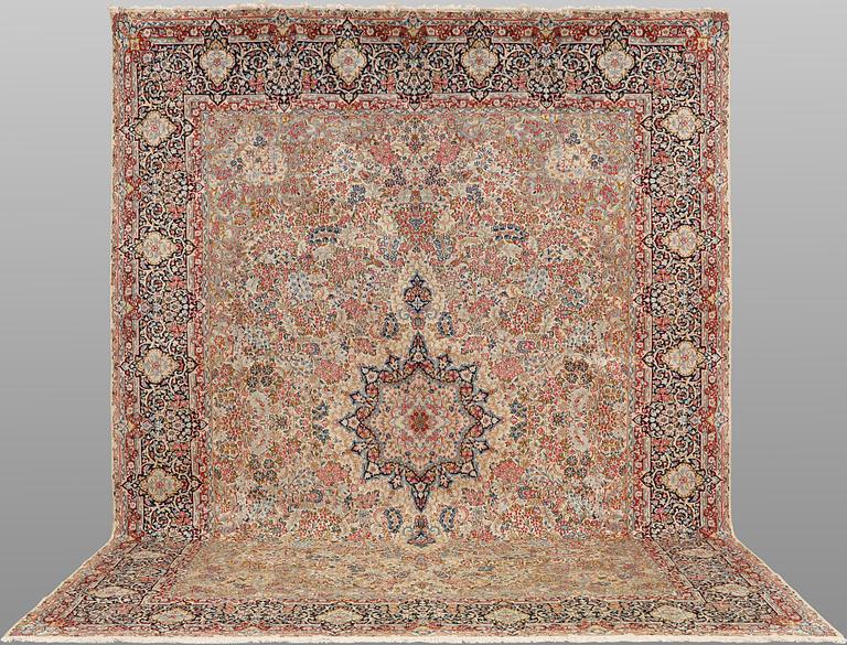 A 'Millefleur' Kerman Laver carpet, c. 398 x 300 cm.