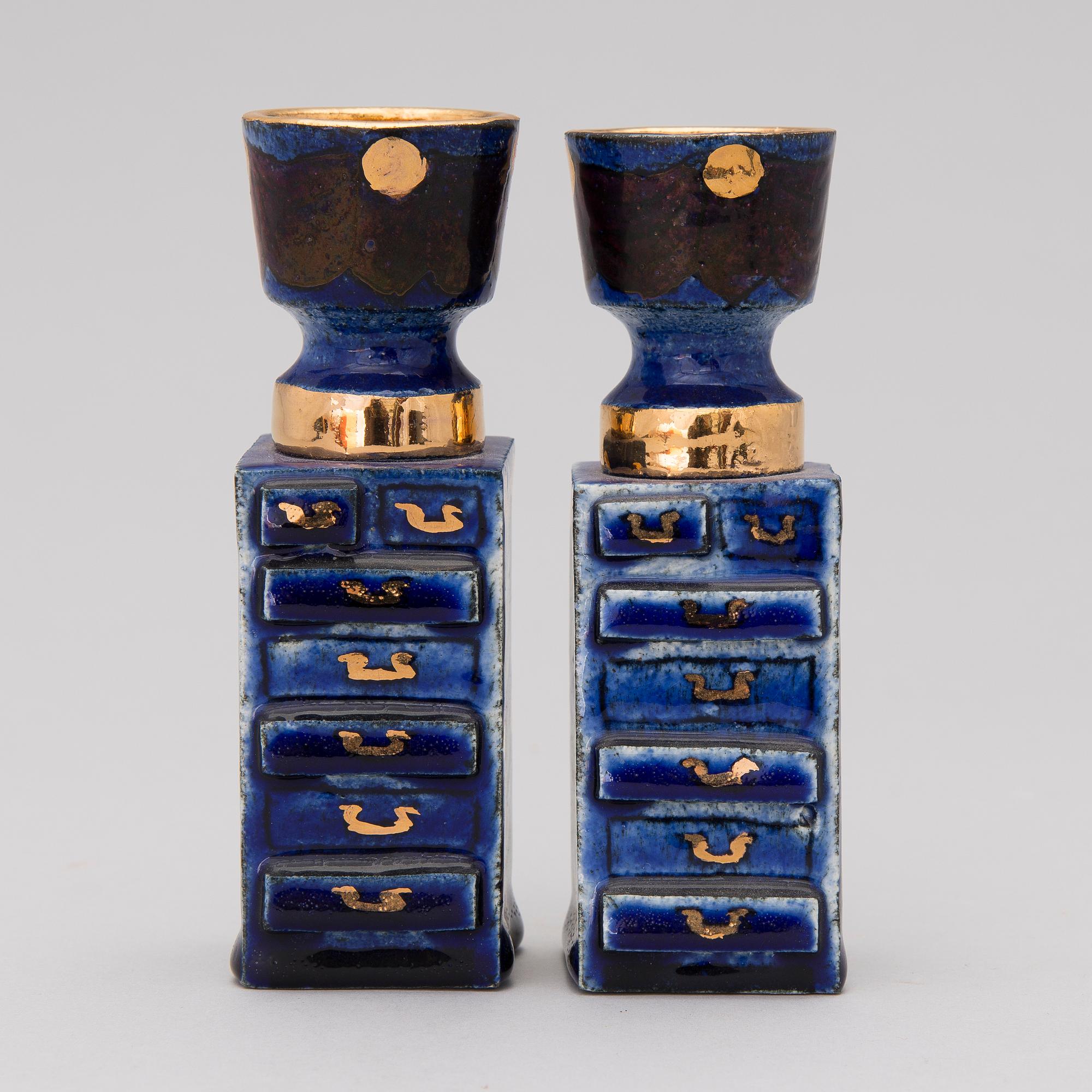 A pair of ceramic candlesticks signed Kaipiainen.