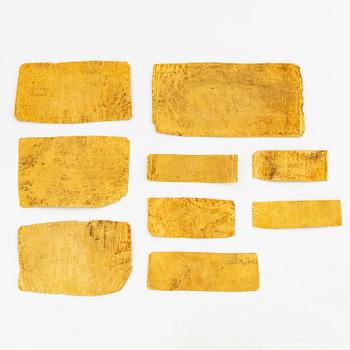 A set of nine presumably modern Egyptian-style gold foil sheets with figures and hieroglyphs.