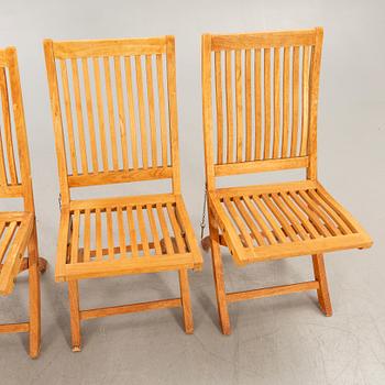 A set of four chairs and a table Royal teak and others, later part of the 20th century.