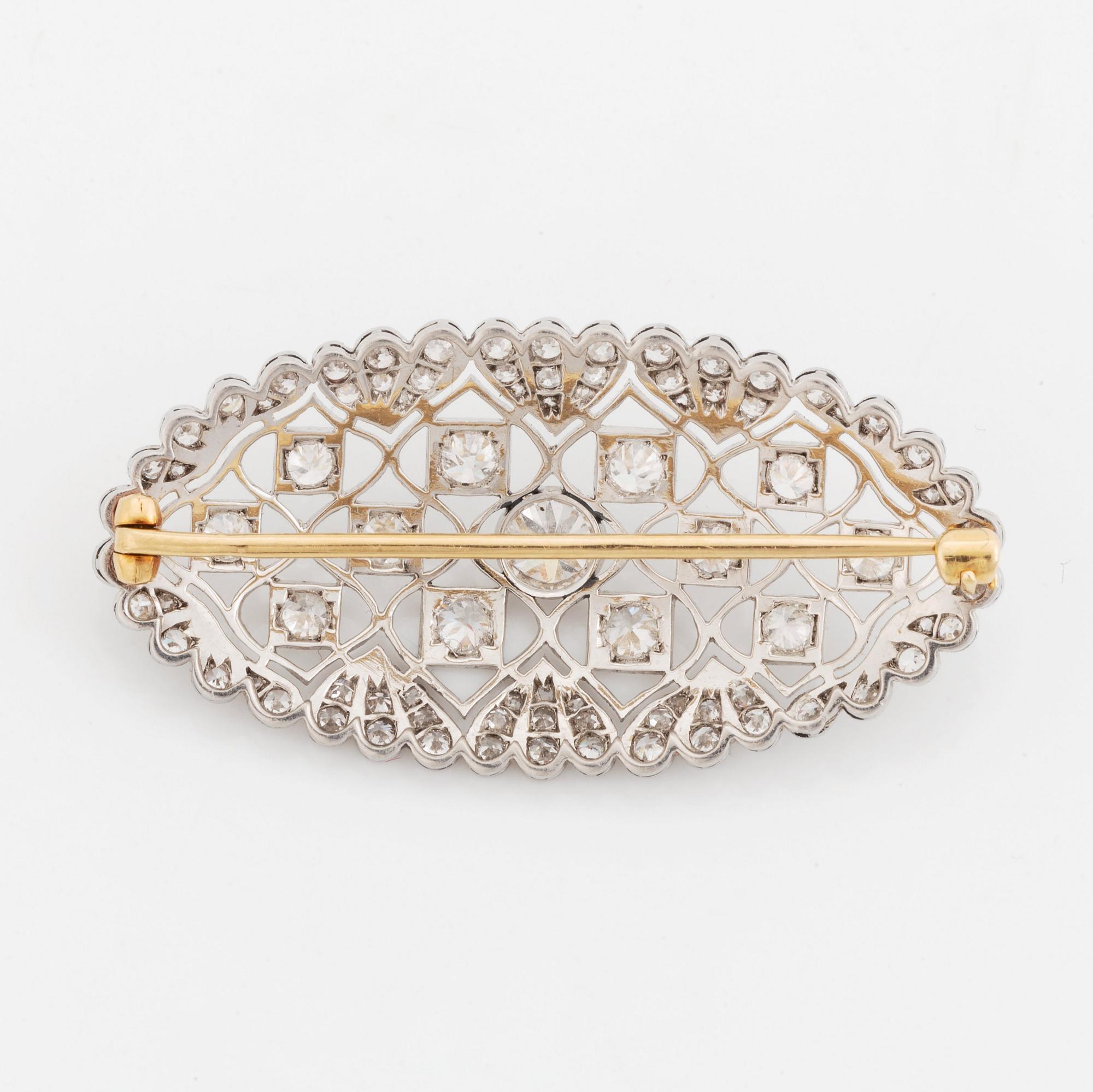 A platinum and gold brooch set with old-cut diamonds.