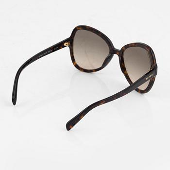 Prada, a pair of tortoise color sunglasses.