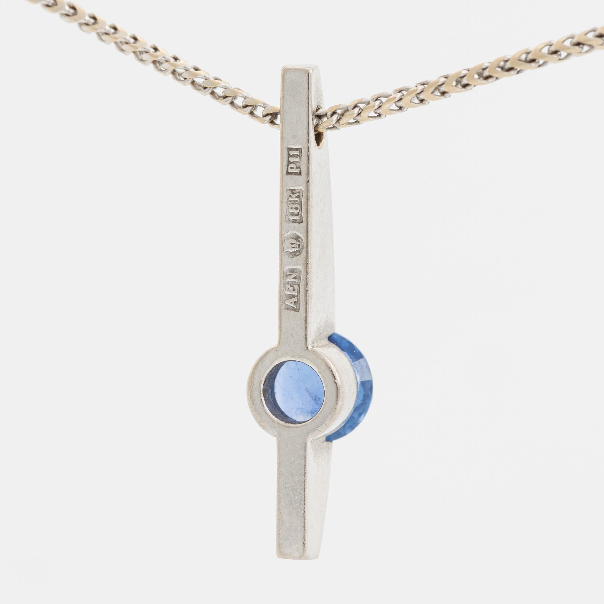 An 18K white gold necklace with a faceted sapphire.