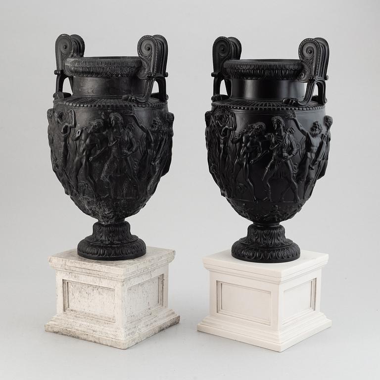 A pair of basalt ware volute vases, 19th century.
