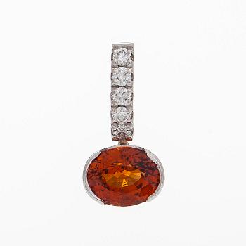 A 14K whitegold pendant, with a garnet and diamonds.