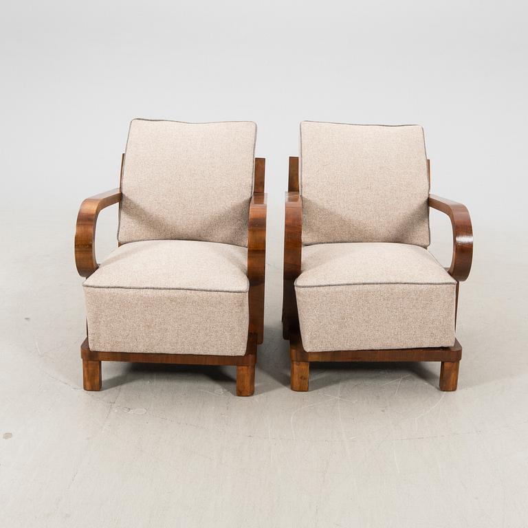 A pair of walnut Art Deco armchairs.