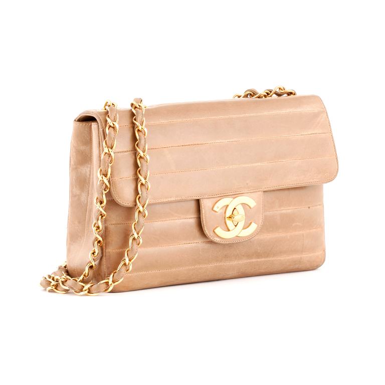 CHANEL, a beige leather flap bag.