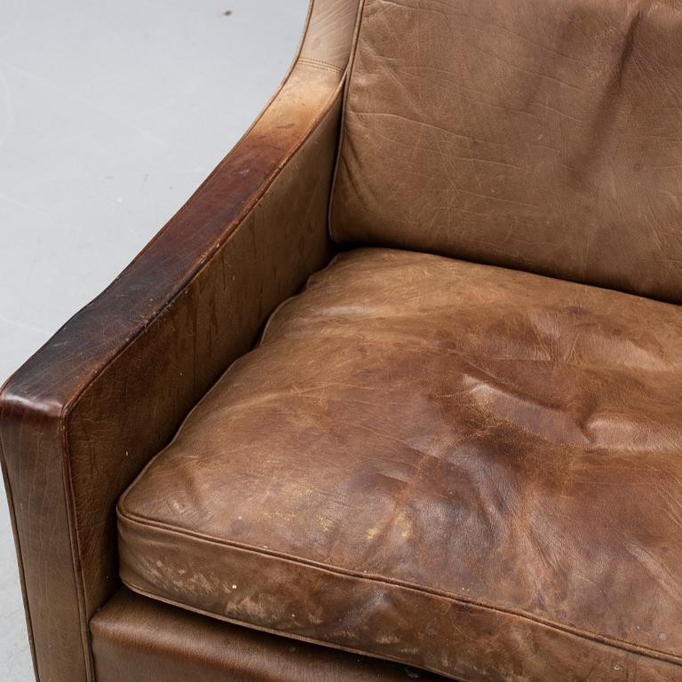 A 1960s easy chair and foot stool.