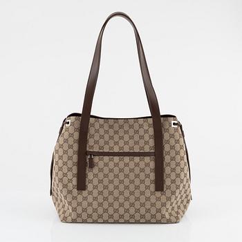 Gucci, a canvas handbag.