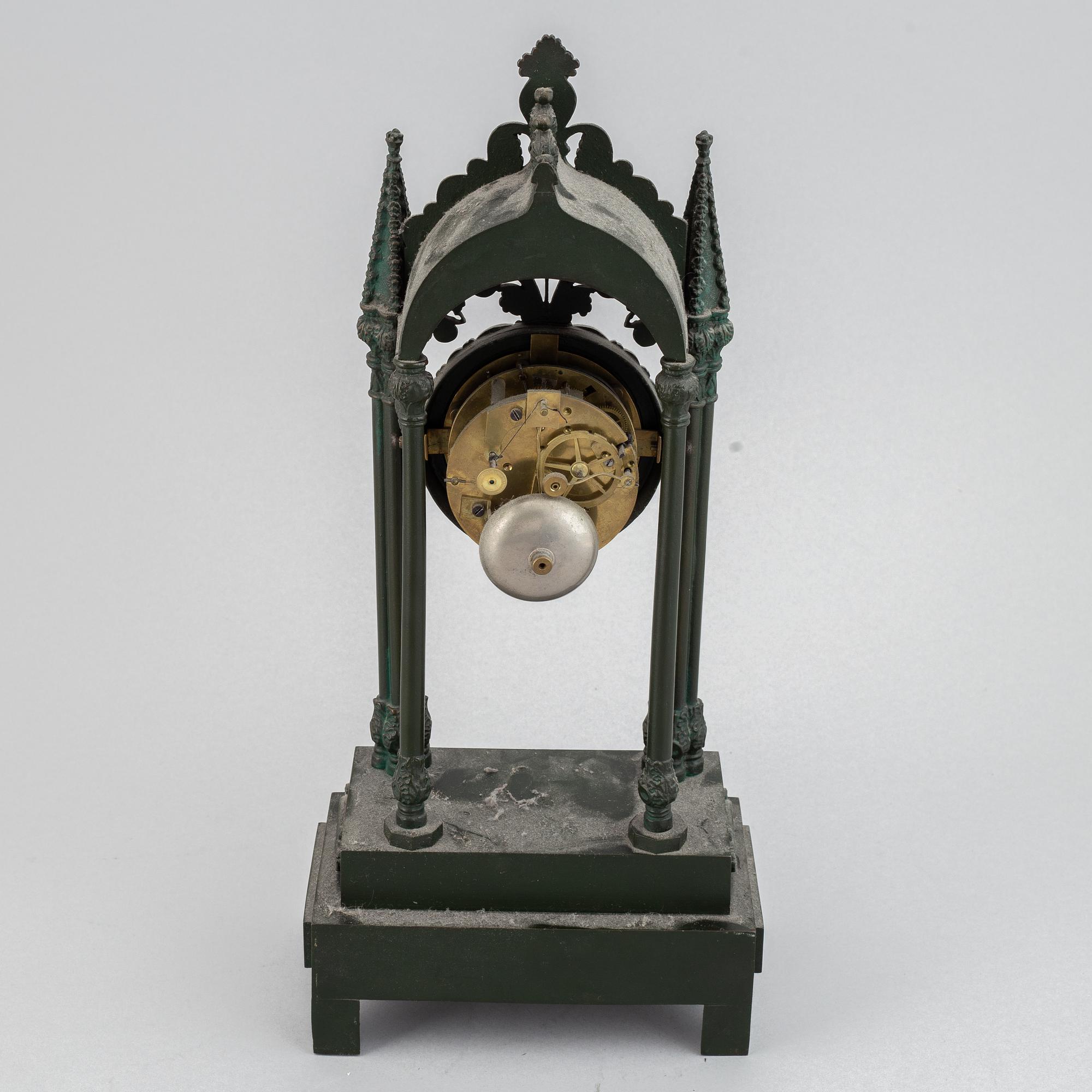 A cast iron gothic revival mantel clock, late 19th century.