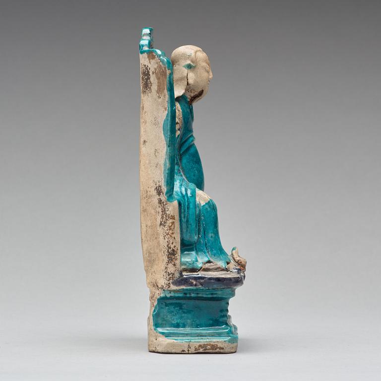 A turquoise and purple glazed figure of a dignitary, Qing dynasty, Kangxi (1662-1722).