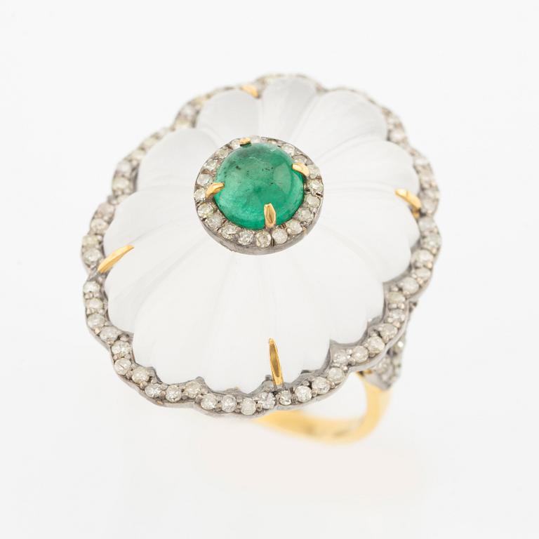 Ring with cut rock crystal, diamonds, and cabochon-cut emerald.