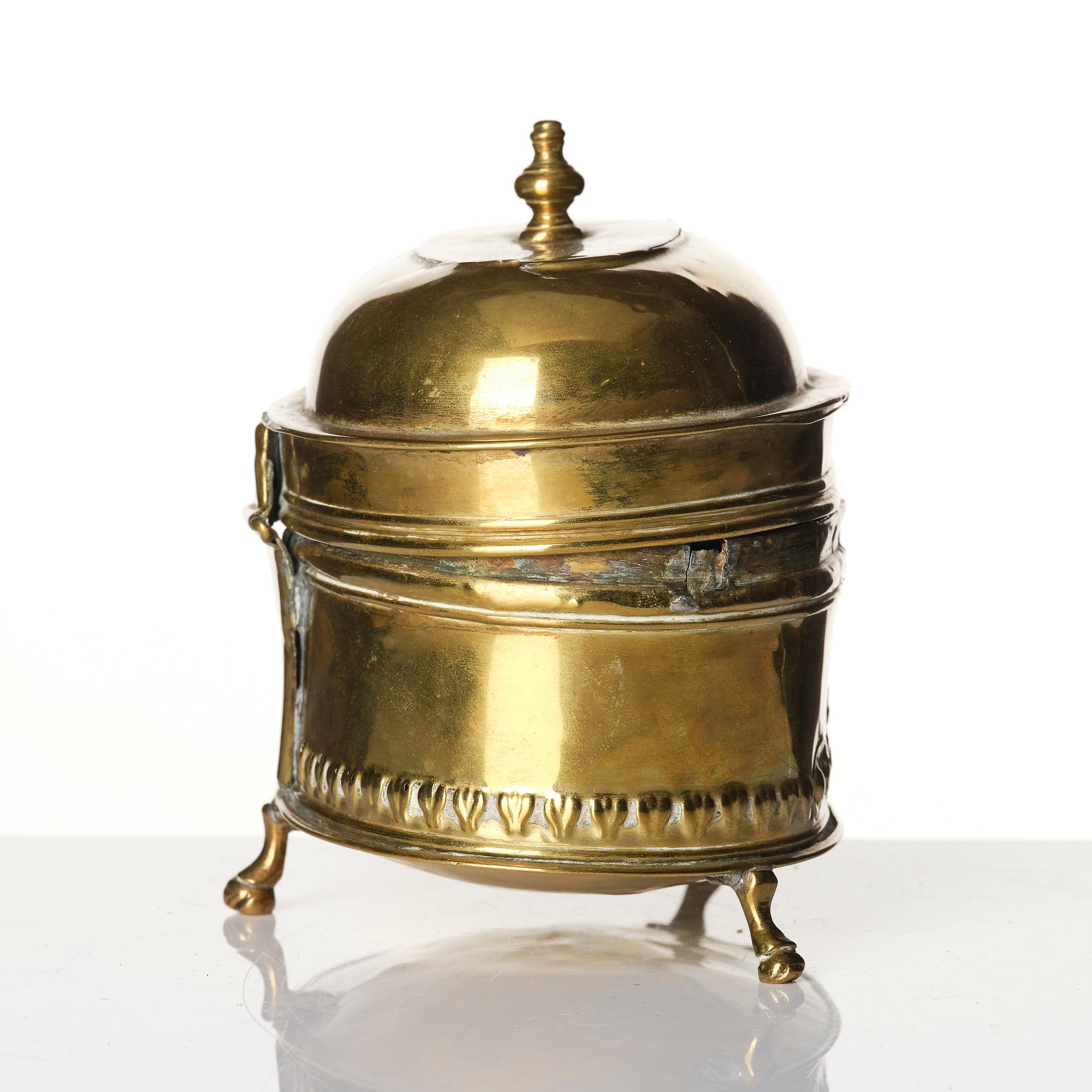 A baroque repousse brass pyxis, 18th century.