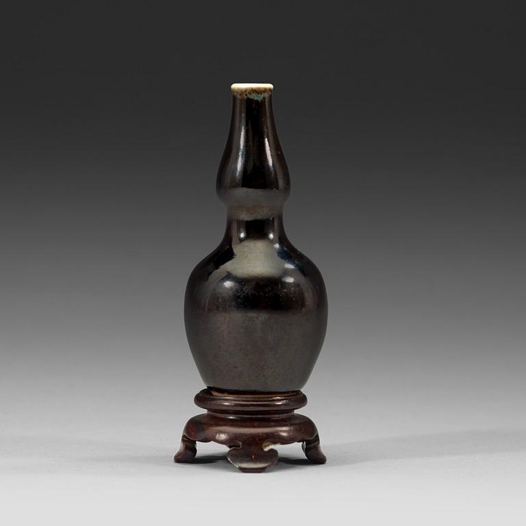 A black-glazed double gourd vase, Qing dynasty, 19th century.