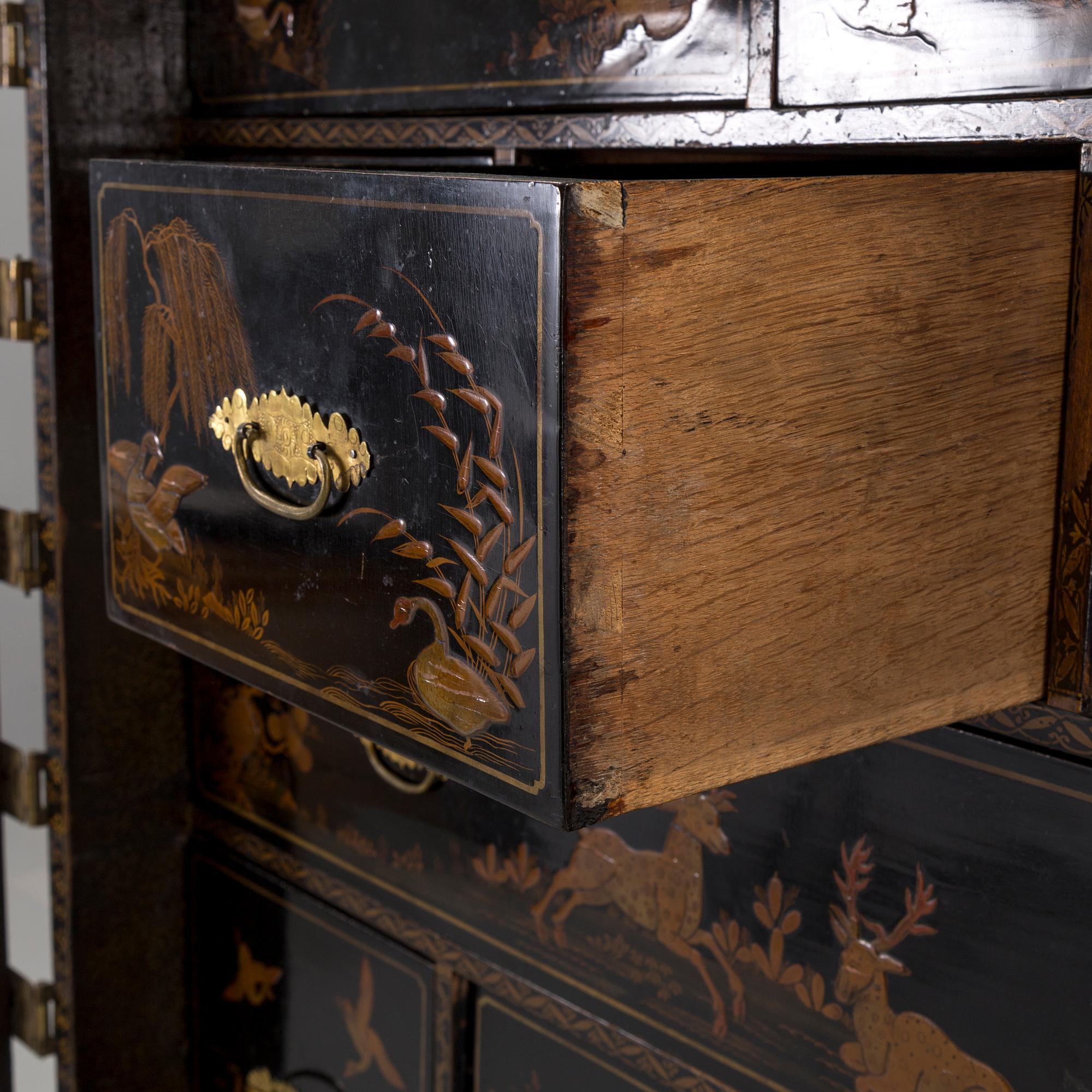 AN early 18TH CENTURY PROBABLY ENGLISH Japanned laquer cabinet on stand.