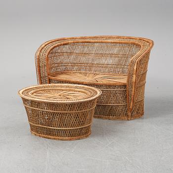 A late 20th Century rattan sofa with table.