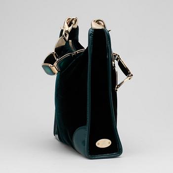 CÉLINE, a green velvet handbag.
