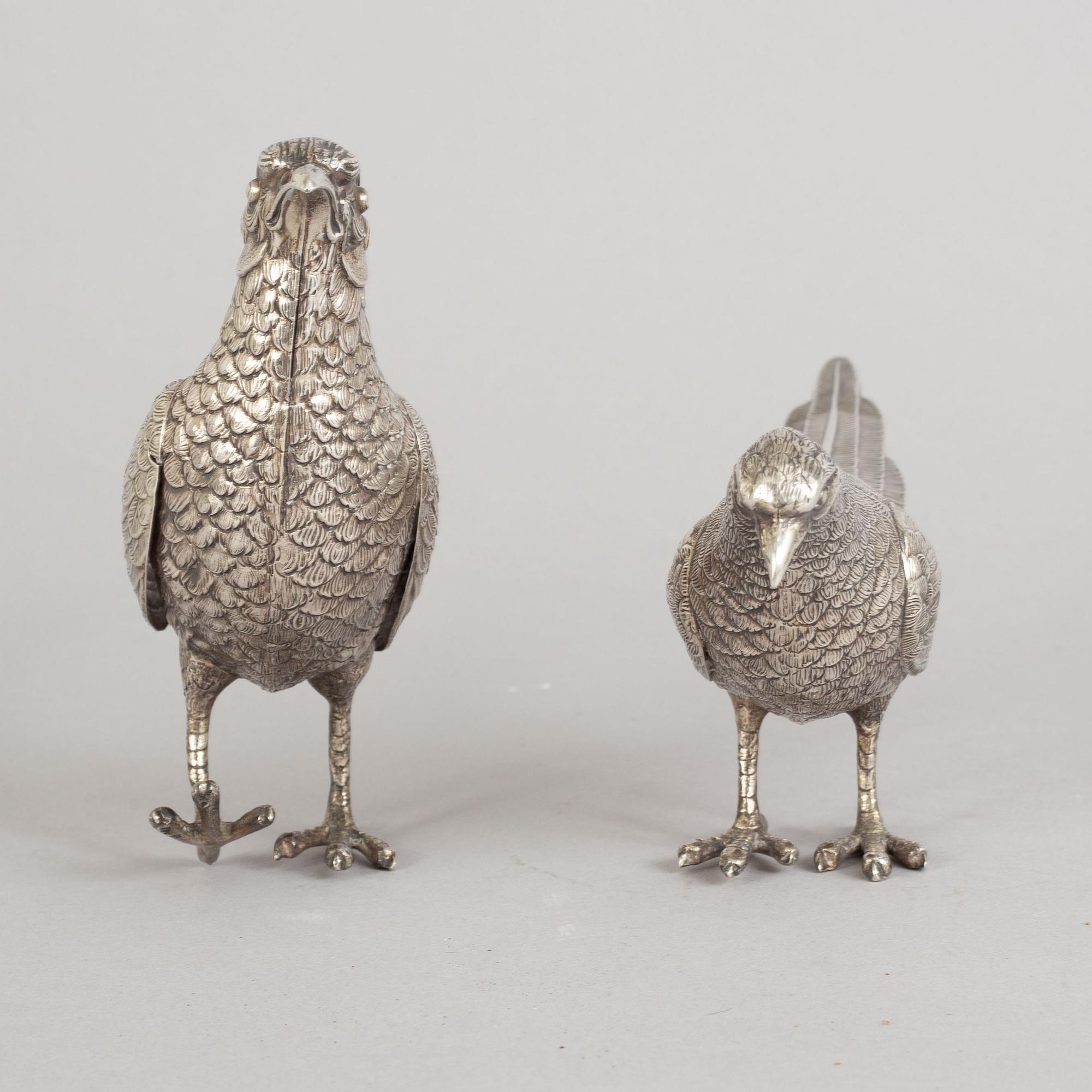 A pair of Spannish 20th century silver pheasants.