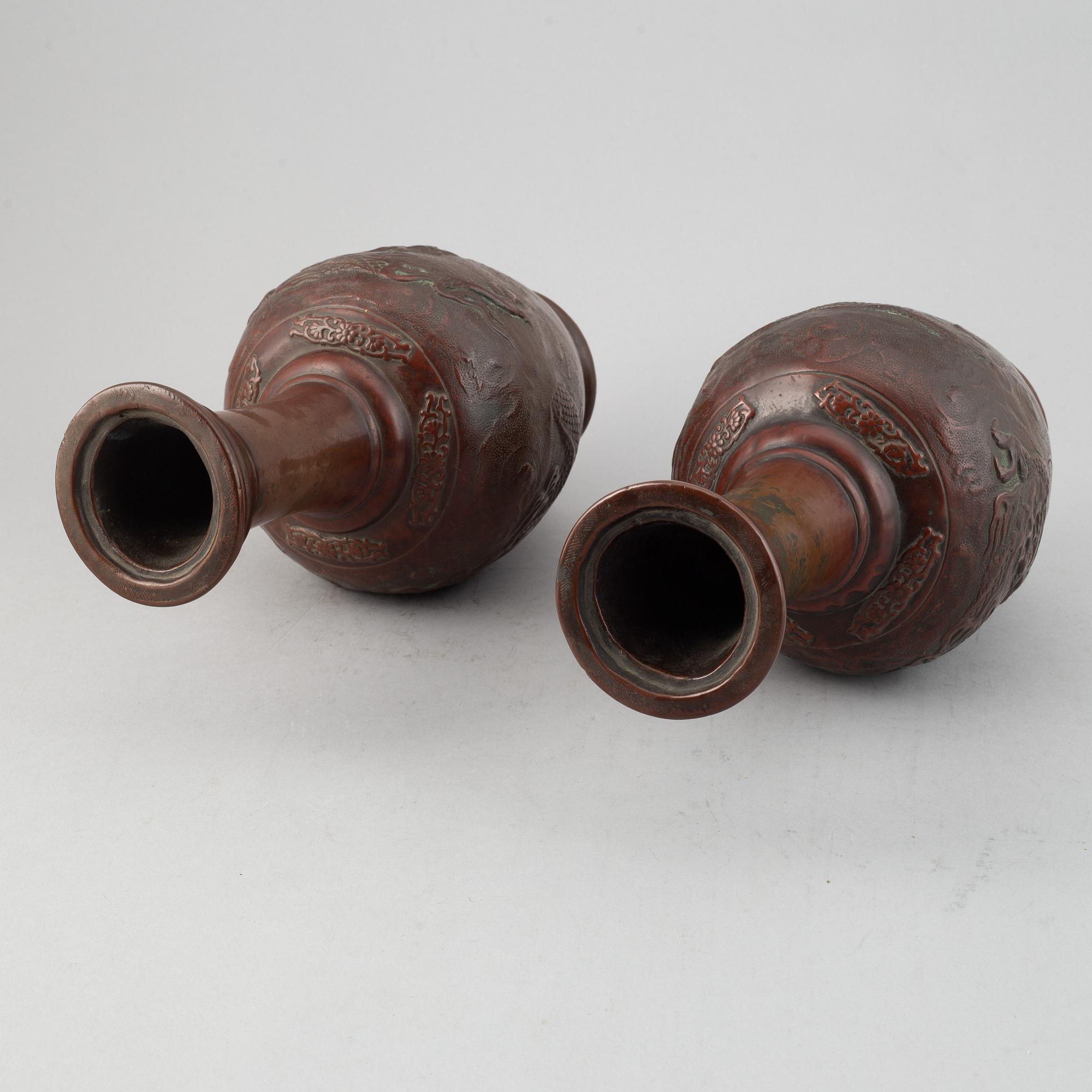 A pair of Japanese copper alloy temple vases, Meiji period (1868-1912).