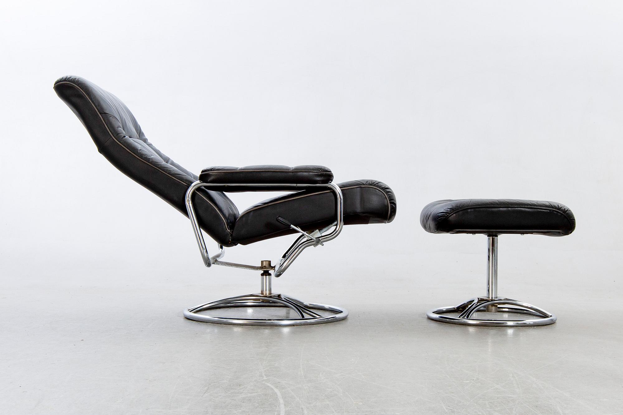 A leather swivel armchair and stool, Söderbergs  1980s.