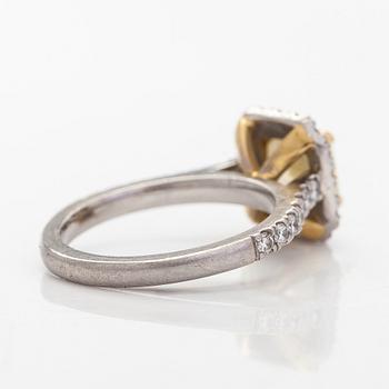 platinum ring with yellow radiant-cut diamond and brilliant cut diamonds.