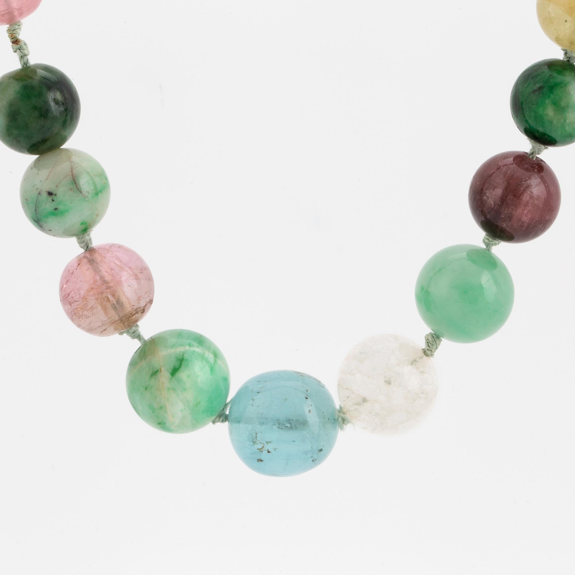 A necklace of multi-coloured stone beads with an 14K gold clasp.