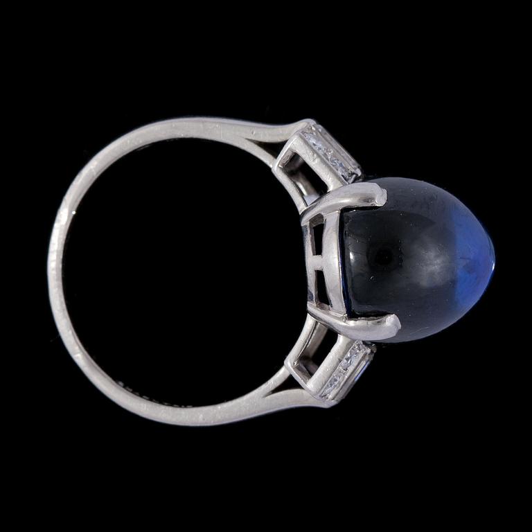 A cabochon cut blue Ceylon sapphire, 12.88 cts, and diamond ring, 1930's.