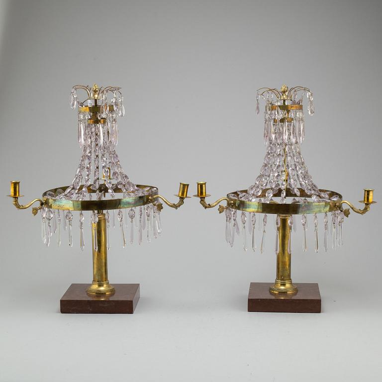 A pair of late Gustavian style three-light candelabra.