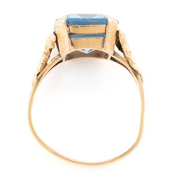 18K gold ring with a blue synthetic stone.