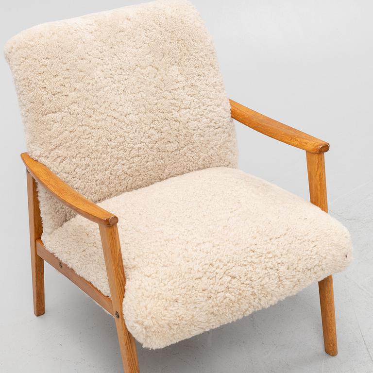 An oak easy chair with sheepskin upholstery. second part of the 20th Century.