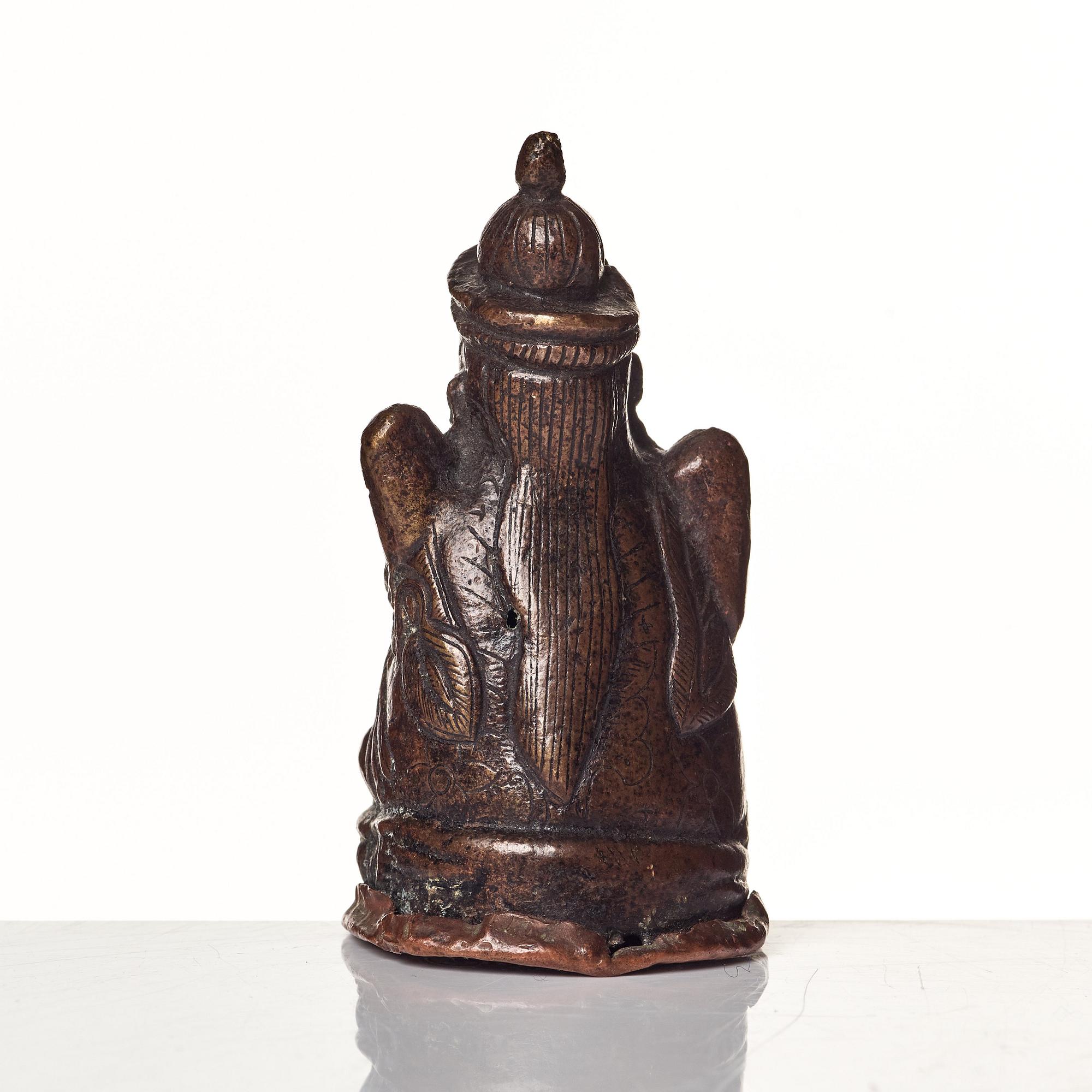 A Tibetan copper alloy figure of a deity.