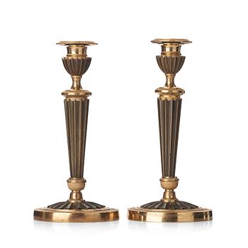 75. A pair of French Empire early 19th century candlesticks.