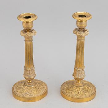 A circa 1900 empire style brass candlesticks.