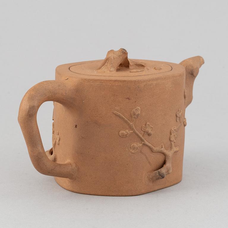 A Yixing pottery tea pot with cover, China, 20th Century, with seal mark.