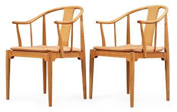A pair of Hans J Wegner cherrywood and beige leather 'China chairs', Fritz Hansen, Denmark 1988.