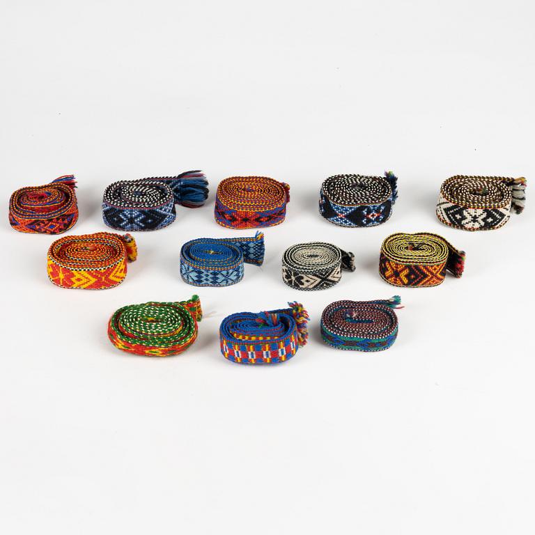 Twelve woven multicoloured bands, 20th Century.