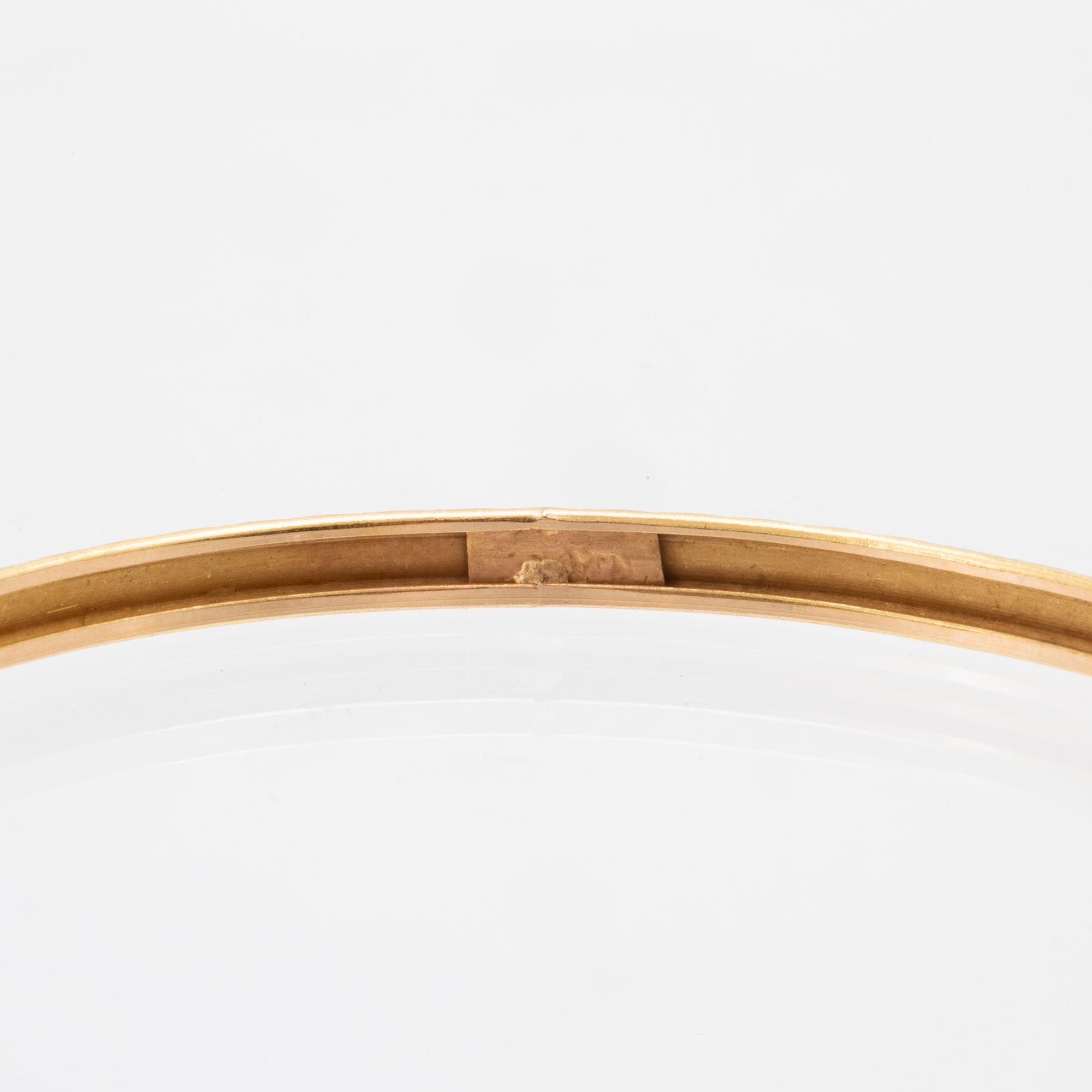 A pair of 18K gold bracelets for children.
