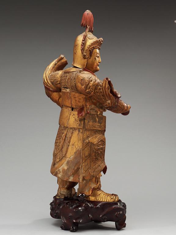 A lacquered and gilt wooden figure of a warrior, Qing dynasty, ca 1800.