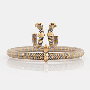 A Cartier bracelet and a pair of earrings in steel and 18K gold.