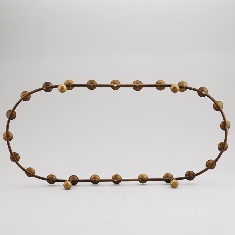 A mid 20th Century brass candle ring.