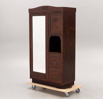 An early 20th century oak cabinet with drawers.